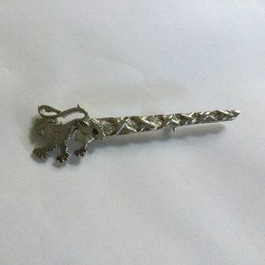 Silver tone metal pin brooch lion?